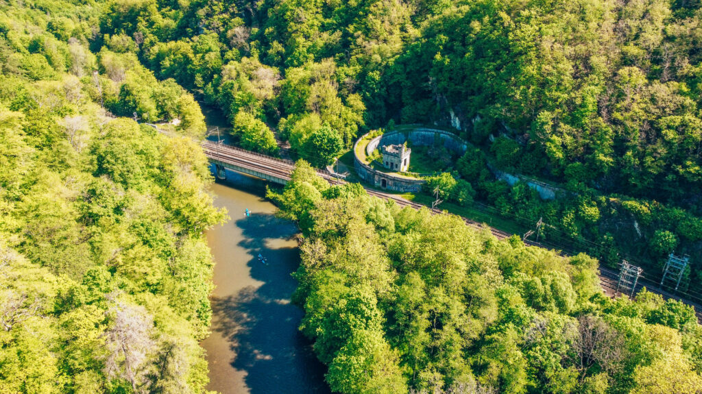 Panoramic view of Château de Walzin while walking along the Lesse River.